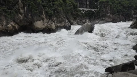 White Water in Tiger Leaping Gorge with Arch Bridge Stock Footage 340130611