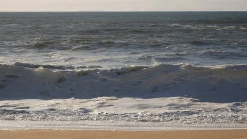 White water waves breaking on the sandy beach, close up, compressed perspective Stock Footage 103290987