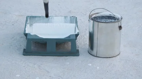 White waterproof paint in green container and roller at rooftop. Stock Footage 139770714