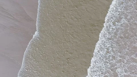 White waves kiss soft sand with gentle rhythm Stock Footage 346261616
