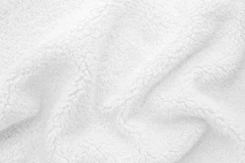 White wavy lambswool texture close up. Warm sheep's wool fabric for blankets. Stock Photos