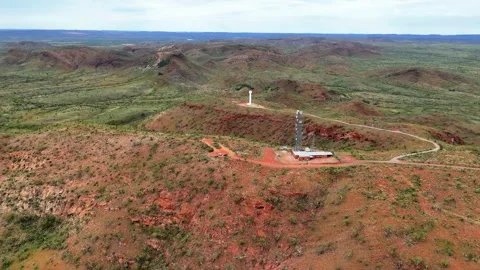 White weather radar Tower Red Desert Landscape with Mount Isa City in distance Stock Footage 328034085