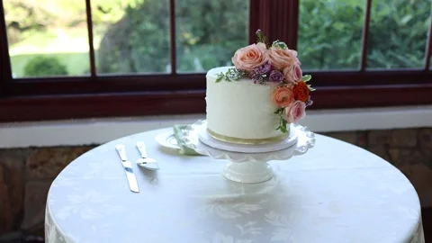 White wedding cake with flowers on table Stock Footage 338033810