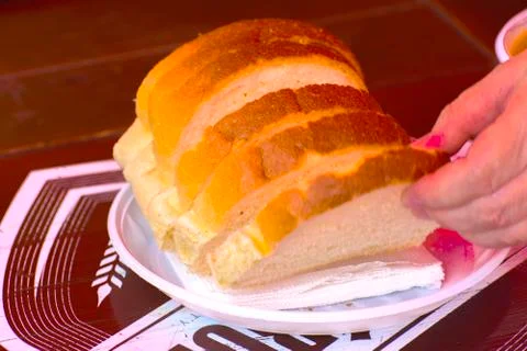 White wheat bread on a plastic disposable plate Stock Photos