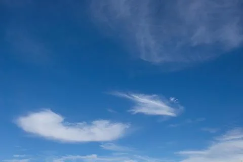White, whispy clouds in a blue sky. Stock Photos