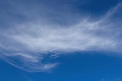 White, whispy clouds in a blue sky. Stock Photos