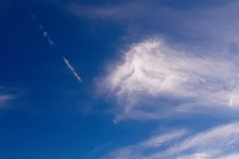 White, whispy clouds in a blue sky. Stock Photos