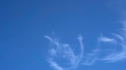 White whispy clouds rolling across a clear blue sky Video stock 255023643