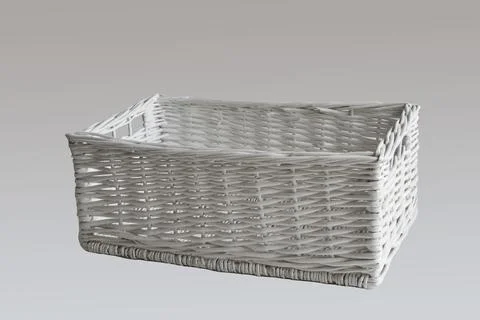 White wicker basket of rectangular shape isolated on gray background. Stock Photos