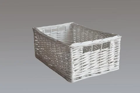 White wicker basket of rectangular shape isolated on gray background. Stock Photos
