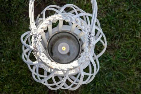 White wicker decorated lantern over green grass Fotos Stock