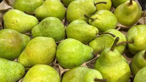 White Williams pears arranged in a crate on a greengrocer's shelf Stock Footage 307793284