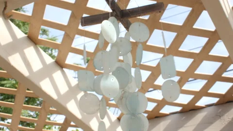 White wind chimes blowing in the wind. Stock Footage 133156222