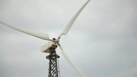 White wind generator closeup, cloudy grey sky bg Stock Footage 97101204