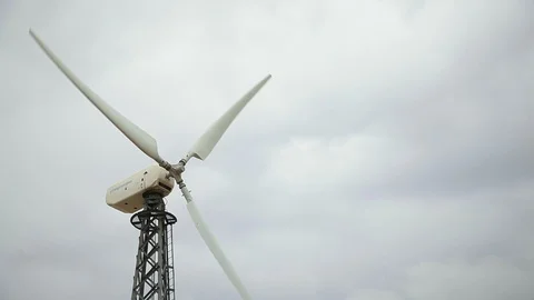 White wind generator closeup, rainy sky bg, grey day Stock Footage 97101169