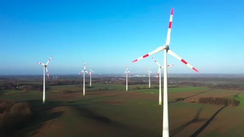 White wind turbines rotate in the wind under blue sky Video stock 169281423