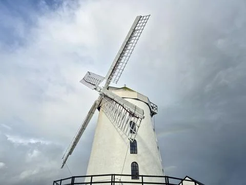 White windmill against dramatic cloudy sky 스톡 사진