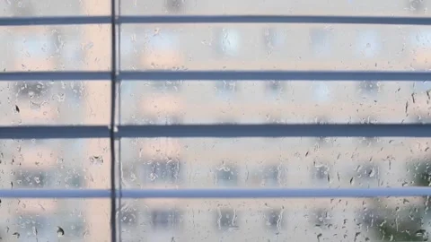 White window blinds swaying in breeze closeup, rainy weather with raindrops Stock Footage 340141896