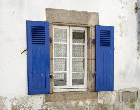 White window with blue shutter Stock Photos