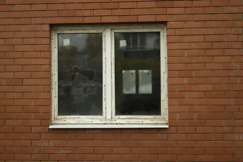 White window in brick wall. Window in building. Red brick wall. Stock Photos