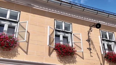 White Window Frames With Hanging Flower Pots in Sibiu Old Town Vídeos de archivo 323077986