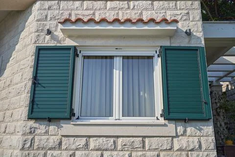 White window in a house with open plastic shutters Stock Photos