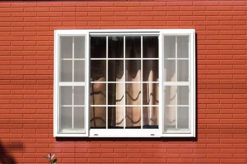 White window with red brick wall.  Stock Photos