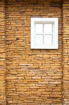 White window on the stone wall Stock Photos