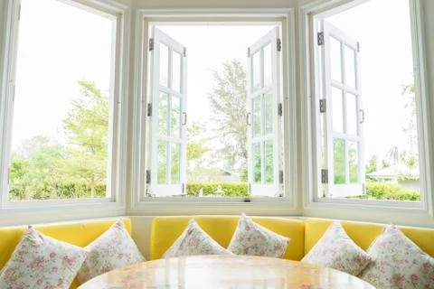 White window with yellow sofa Stock Photos