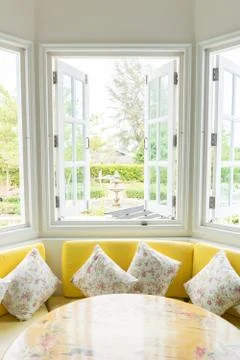 White window with yellow sofa vertical Stock Photos