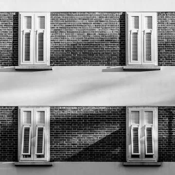 White windows on a building made from bricks Stock Photos