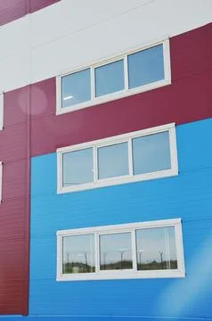 White windows in modern plastic frames on the facade of an industrial offic.. 스톡 사진