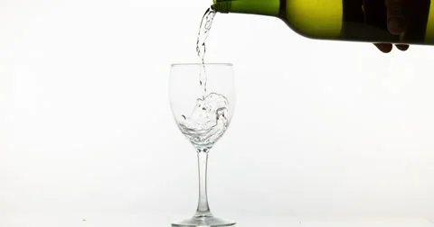 White Wine being poured into Glass, against White Background, Slow motion 4K Stock Footage