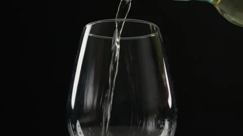 White Wine Being Poured Quickly and Messily into a Large Wine Glass Stockbeeldmateriaal 246828379
