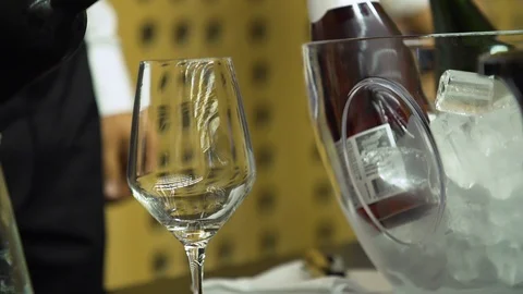 White wine being poured into wine glass, blurred wine festival background. Stock Footage 120843879