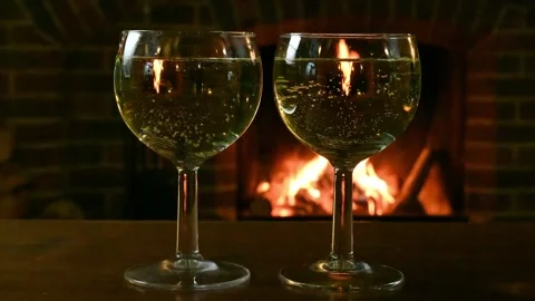 White wine in front of the log fire Stock Footage 254900393