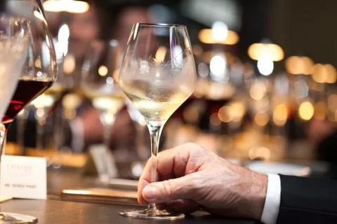 White wine on hand with dinner on restaurant Stock Photos