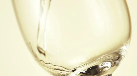 White wine pouring into a glass from a bottle Stock Footage