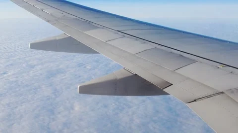 White wing aircraft visible plane flies high above endless rippled carpet clouds Stock Footage 327643888
