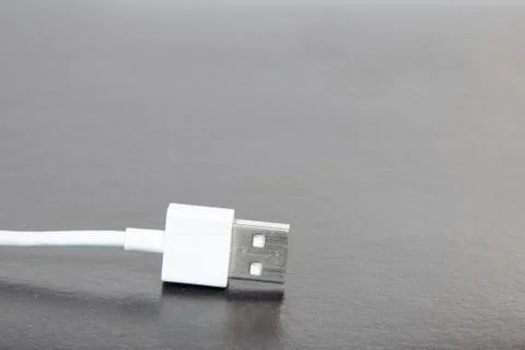 White wire and jack for mobile device charging office object table gray persp Stock Photos