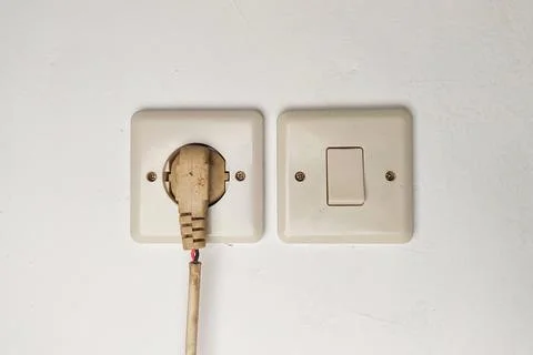 The white wire is connected to the terminal and the light switch. Stock Photos