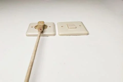 The white wire is connected to the terminal and the light switch. Stock Photos