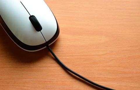 White Wired Computer Mouse on a Wooden Table Stock Photos