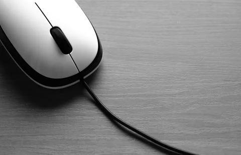 White Wired Computer Mouse on a Wooden Table Stock Photos