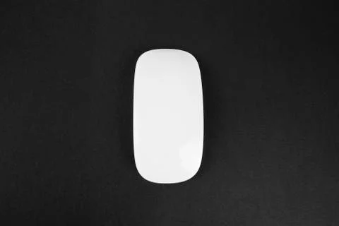 White wireless computer mouse on black background. Modern sleek design for Stock Photos