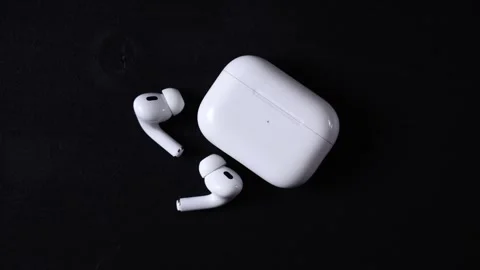 White Wireless Earbuds and Charging Case on Black Surface Stock-Footage 305441370