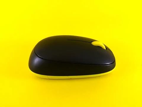 White wireless mouse on yellow background, minimal, flatlay Stock Photos