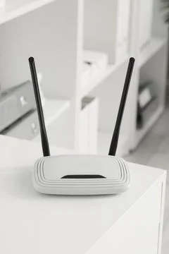 White wireless router with two black antennas on a clean white surface, inter Stock Photos