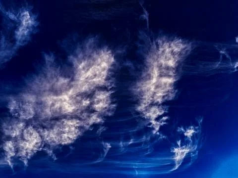 White wispy cloud in blue sky. Australia. Stock Photos