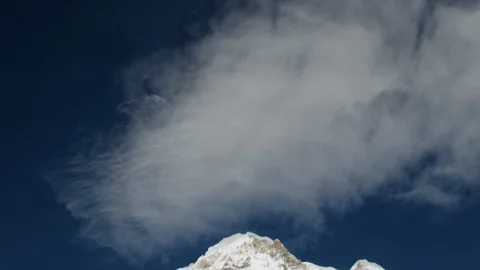 White wispy cloud over a snow clad mountain Stock Footage 113255492
